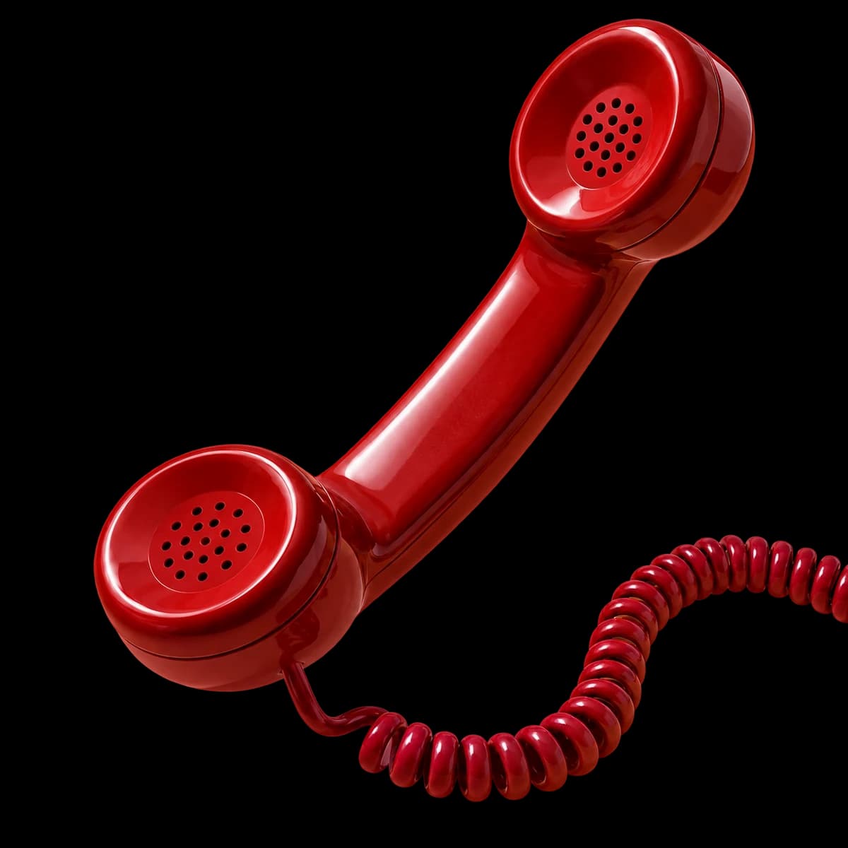 A sculptural red telephone handset with a looping coiled cord